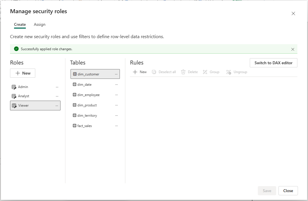 Fabric Manage security roles — three roles listed: Admin, Analyst, Viewer. dim_customer selected. Rules panel empty (Admin has no row filter). Success banner: 'Successfully applied role changes.'